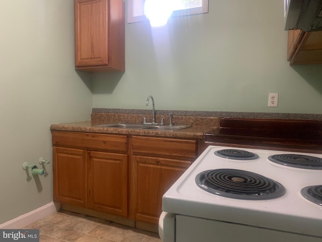 kitchen with range with electric stovetop and sink