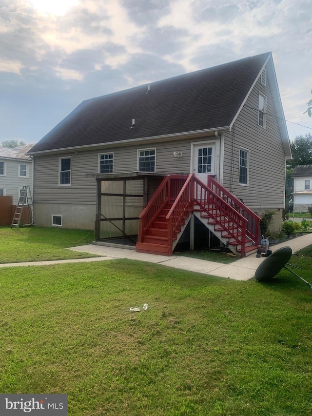 back of house with a lawn