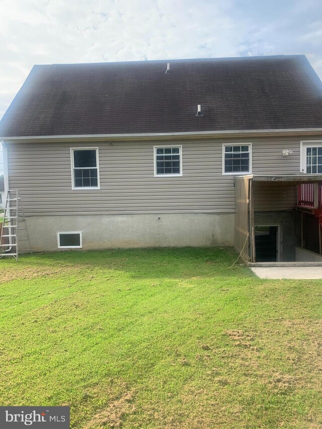 rear view of house with a yard