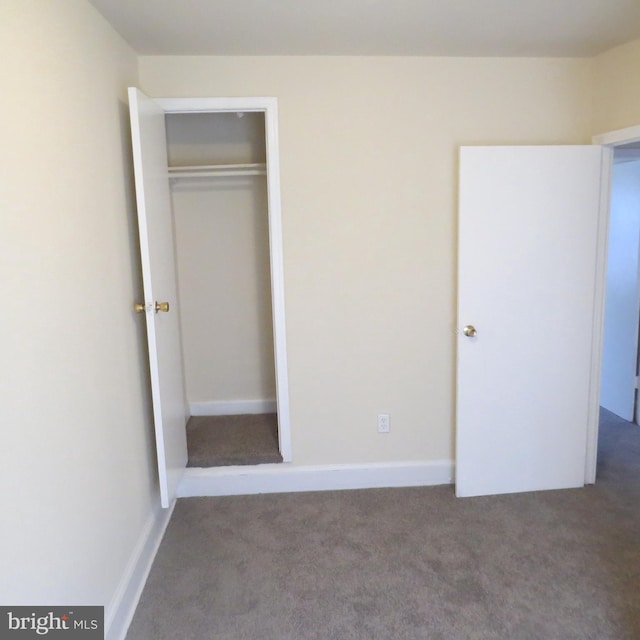 unfurnished bedroom with carpet floors and a closet