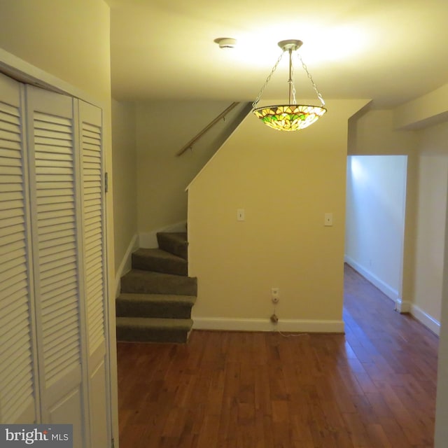 unfurnished dining area with dark wood-type flooring