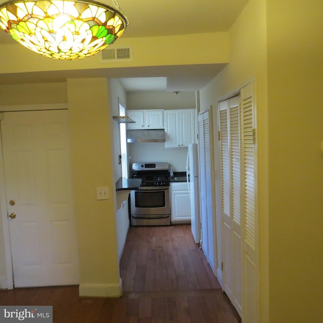 corridor featuring dark hardwood / wood-style flooring