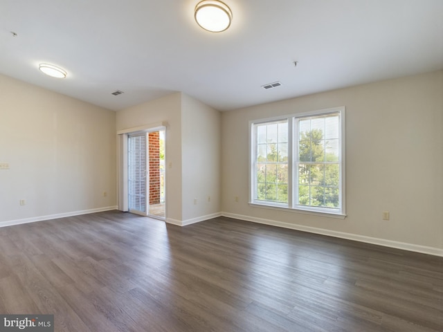 unfurnished room with dark hardwood / wood-style flooring