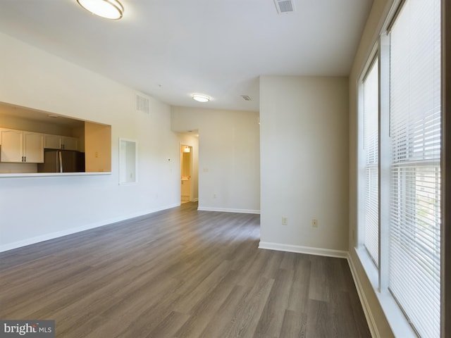 spare room featuring hardwood / wood-style floors and a healthy amount of sunlight