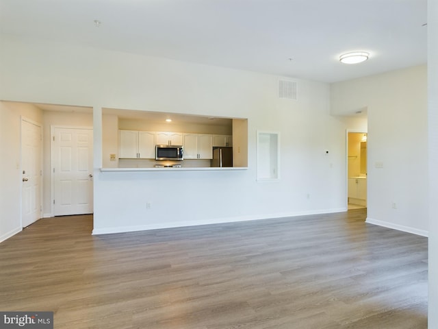 unfurnished living room featuring light wood-type flooring