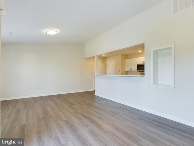 unfurnished living room with light hardwood / wood-style floors