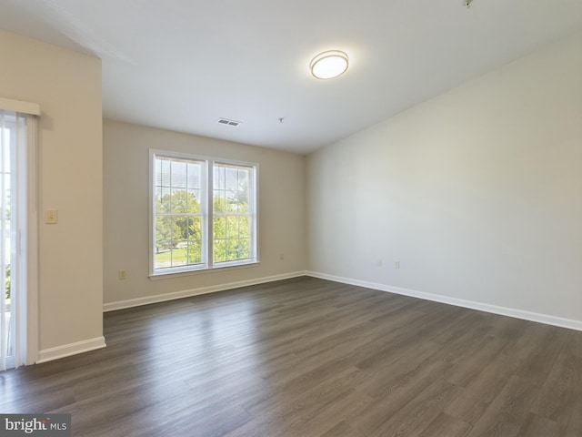 spare room with dark hardwood / wood-style floors