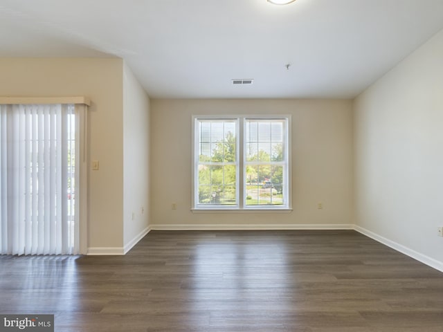 spare room with dark wood-type flooring