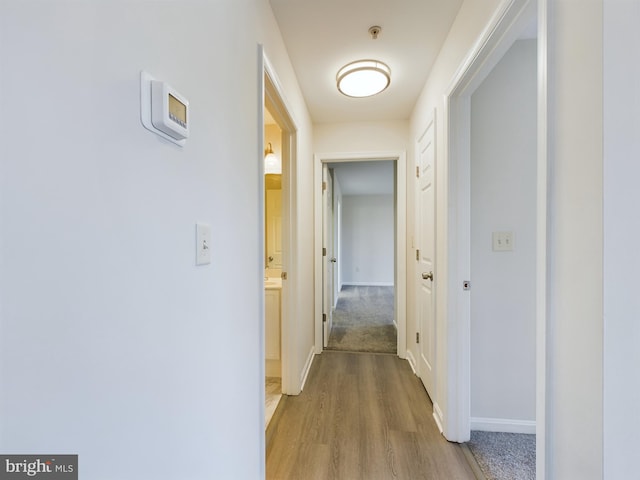 corridor with light wood-type flooring