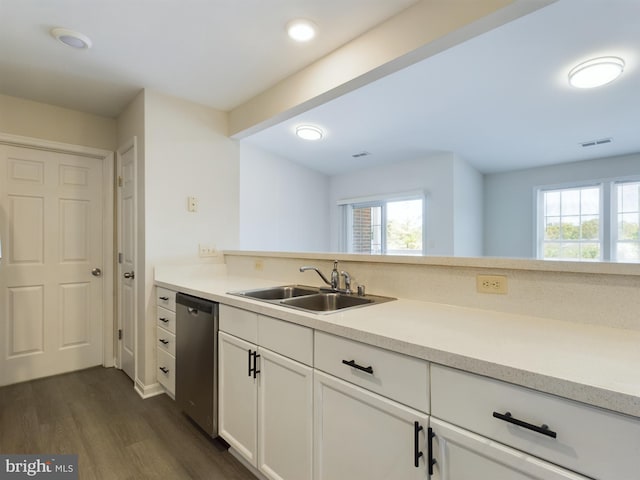 kitchen featuring dishwasher, dark wood-type flooring, sink, and white cabinetry