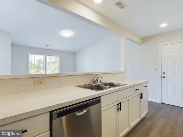 kitchen featuring dark hardwood / wood-style floors, sink, white cabinetry, and stainless steel dishwasher