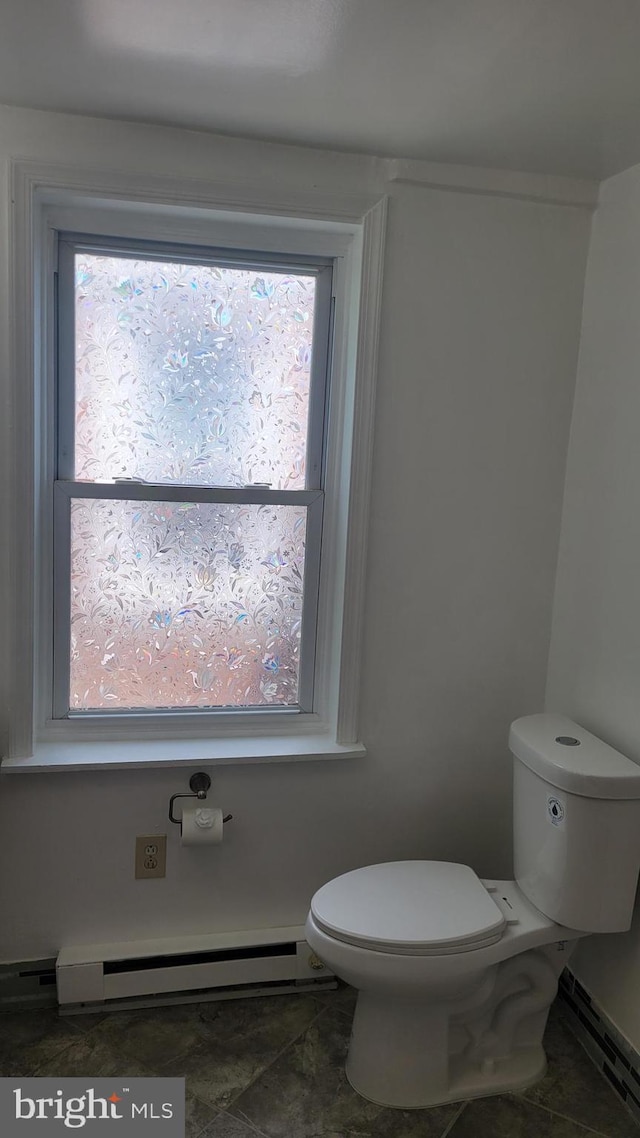 bathroom featuring a baseboard radiator, toilet, and tile patterned floors