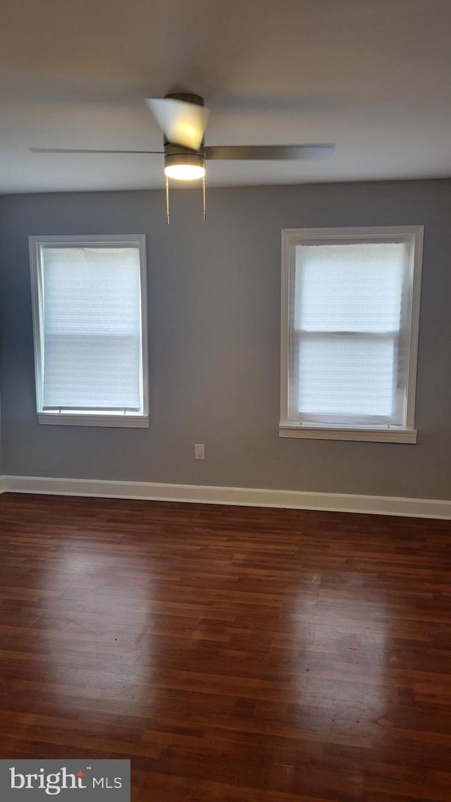 empty room with ceiling fan and wood-type flooring