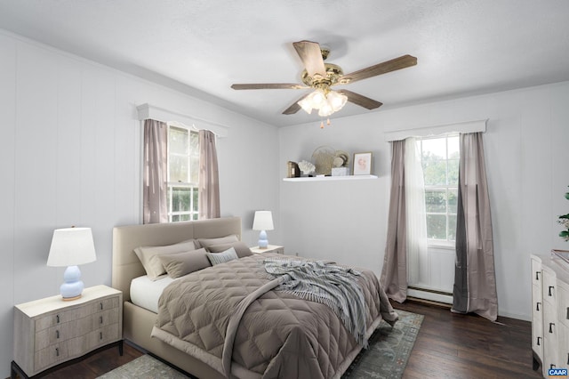 bedroom featuring ceiling fan, dark wood-type flooring, and a baseboard radiator