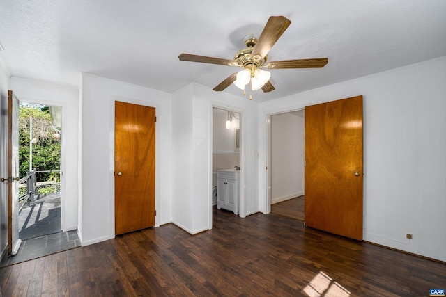 unfurnished bedroom featuring ceiling fan, access to exterior, dark hardwood / wood-style flooring, and ensuite bath