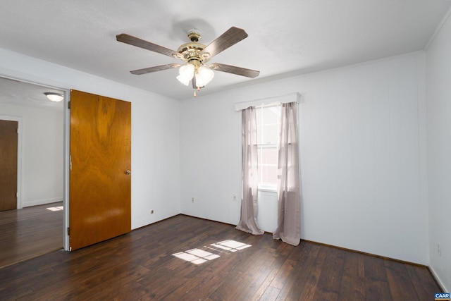 spare room with ceiling fan and dark wood-type flooring