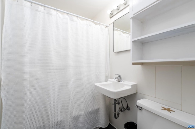 bathroom featuring sink and toilet