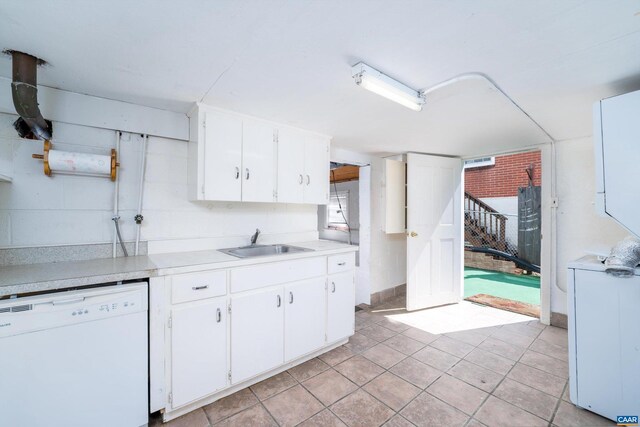 kitchen with white cabinets, light tile patterned floors, white dishwasher, and sink