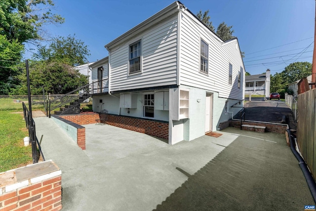 view of property exterior featuring a trampoline and a patio