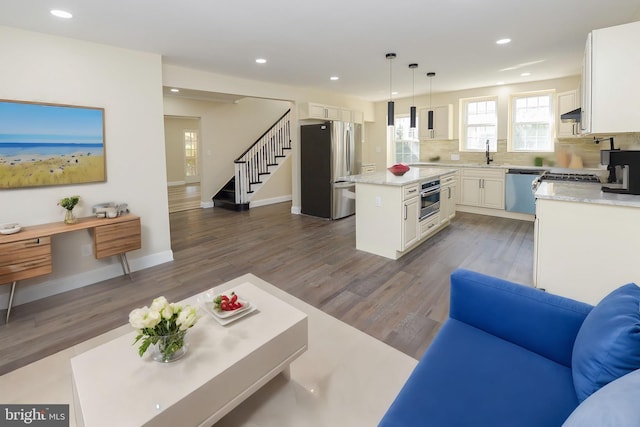 living room with dark hardwood / wood-style floors and sink