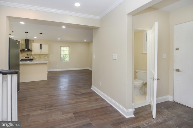 unfurnished living room with crown molding and dark hardwood / wood-style flooring