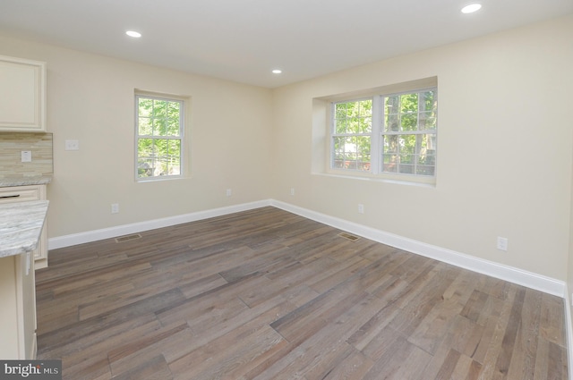 unfurnished living room featuring hardwood / wood-style floors