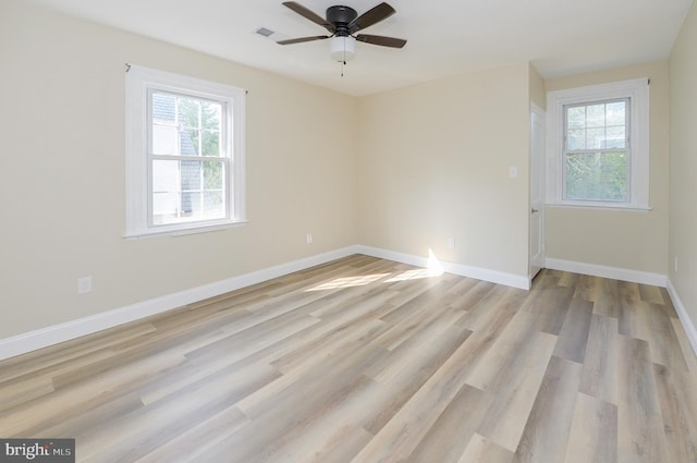 spare room featuring ceiling fan and light hardwood / wood-style flooring