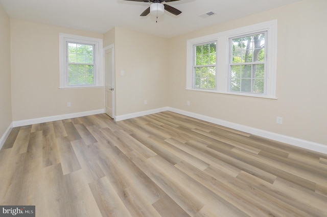 spare room featuring ceiling fan, plenty of natural light, and light hardwood / wood-style flooring