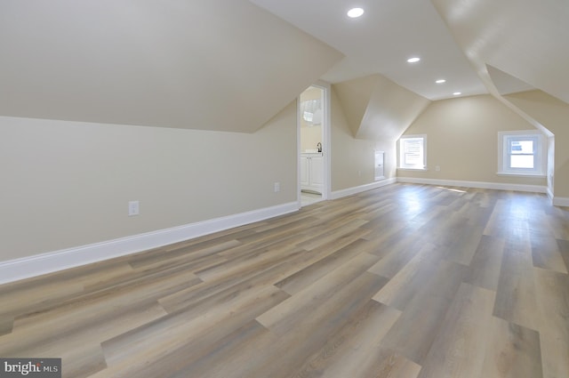 bonus room with lofted ceiling and wood-type flooring