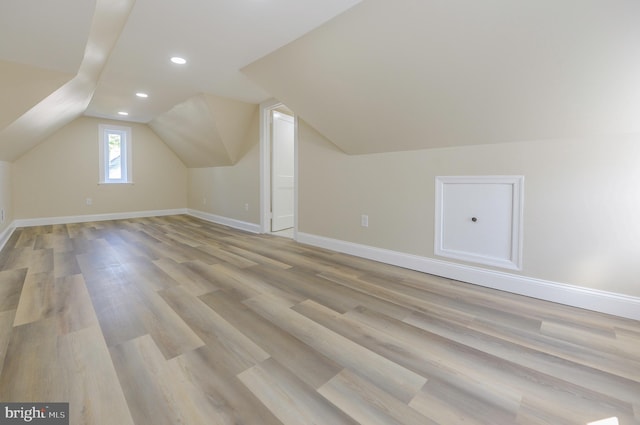 bonus room with light hardwood / wood-style flooring and lofted ceiling