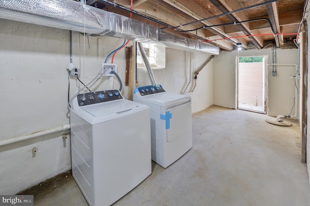 clothes washing area featuring washer and dryer