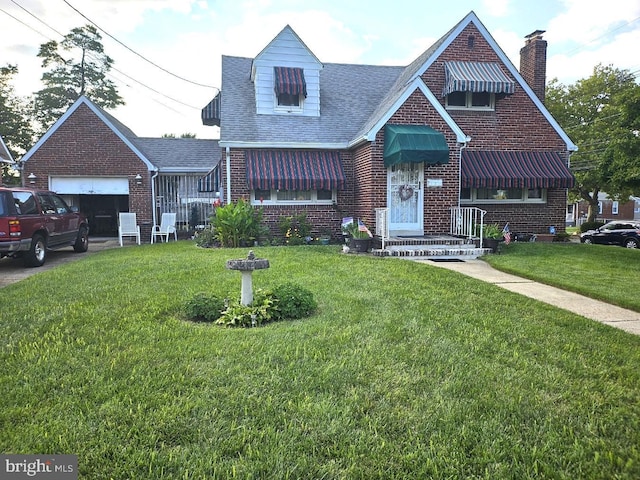 view of front of house featuring a garage and a front lawn