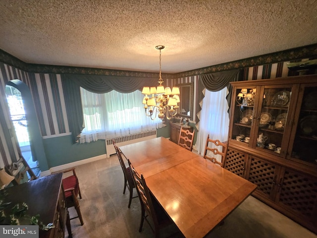 carpeted dining area with a wealth of natural light, an inviting chandelier, radiator, and a textured ceiling