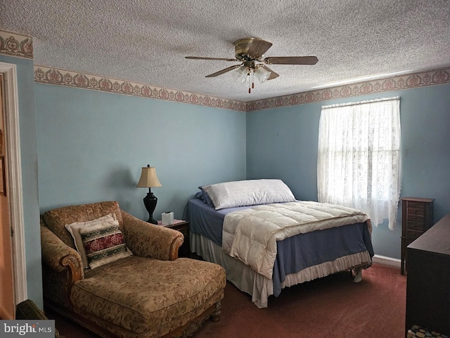 carpeted bedroom with a textured ceiling and ceiling fan