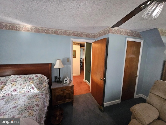 bedroom with a textured ceiling and carpet