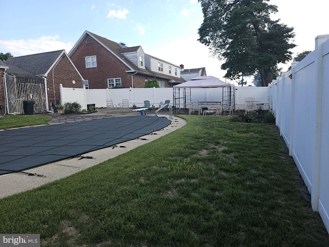 view of yard with a patio area, a gazebo, and a covered pool