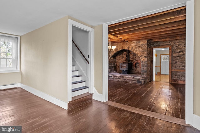 interior space with hardwood / wood-style floors and a wood stove