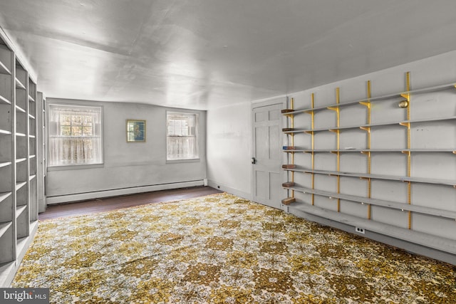 interior space featuring a baseboard radiator and hardwood / wood-style flooring