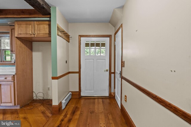 foyer featuring baseboard heating, beamed ceiling, and hardwood / wood-style floors