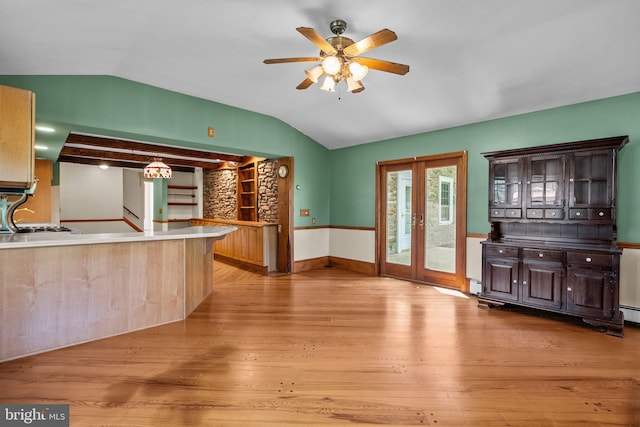 kitchen with ceiling fan, french doors, light hardwood / wood-style floors, and lofted ceiling