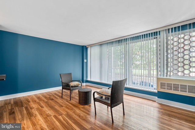 sitting room with wood finished floors and baseboards