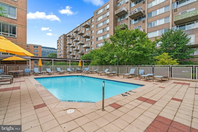 pool featuring a patio area and fence