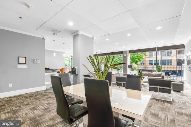 dining room featuring recessed lighting, carpet flooring, baseboards, ornamental molding, and expansive windows