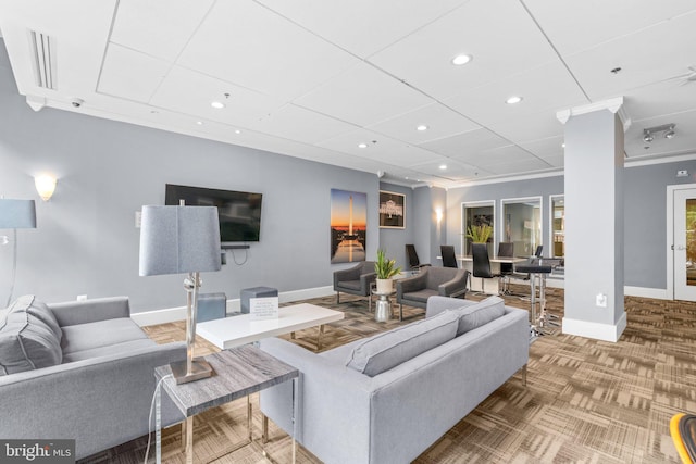 carpeted living area with ornamental molding, recessed lighting, ornate columns, and baseboards