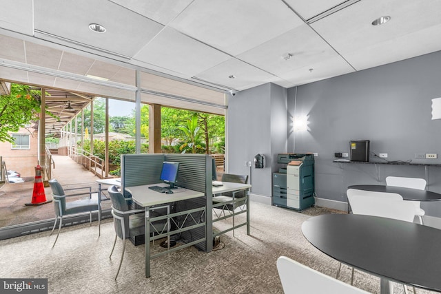 dining room featuring carpet flooring and baseboards