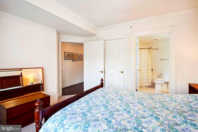 tiled bedroom featuring crown molding and ensuite bathroom