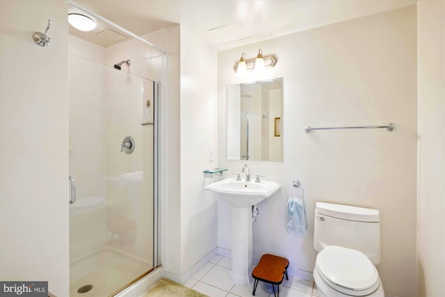 bathroom with tile patterned flooring, toilet, and a shower with door