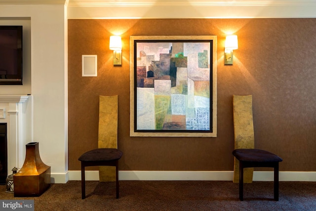 sitting room with carpet and ornamental molding