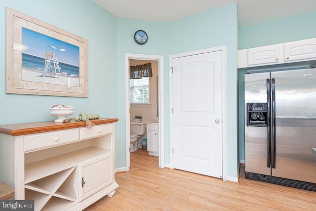 hallway with light hardwood / wood-style floors