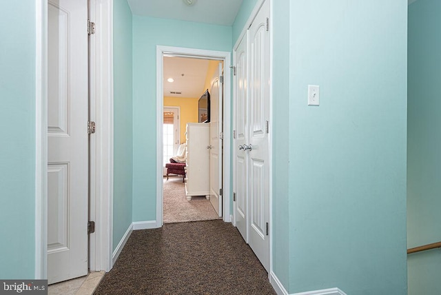 hallway featuring light colored carpet